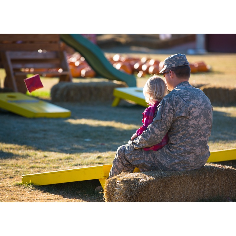 Corn Hole_Military dad girl_sitting on haybale_Hometown Hero.jpg